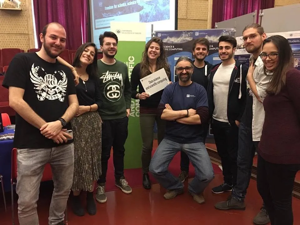 Gabriele and his data science classmates helping Luca Bortolussi promote the course.