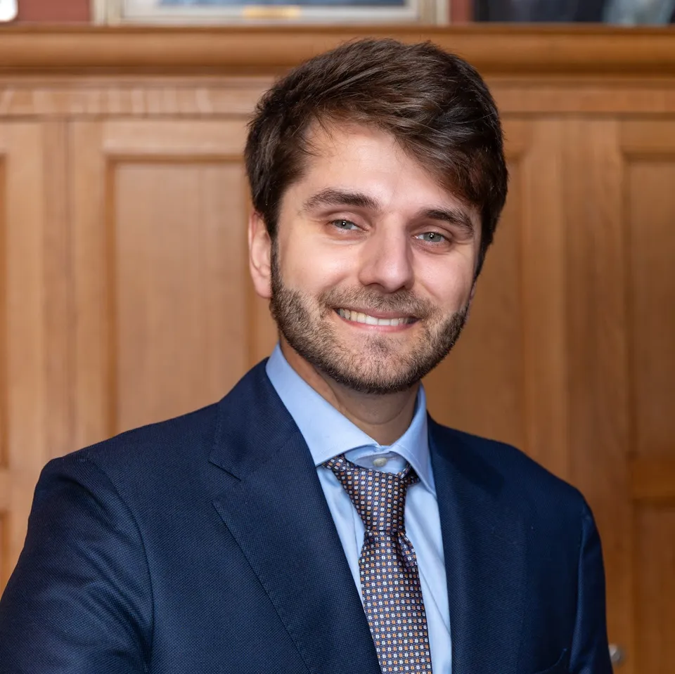 Gabriele Sarti wearing a blue suit and tie