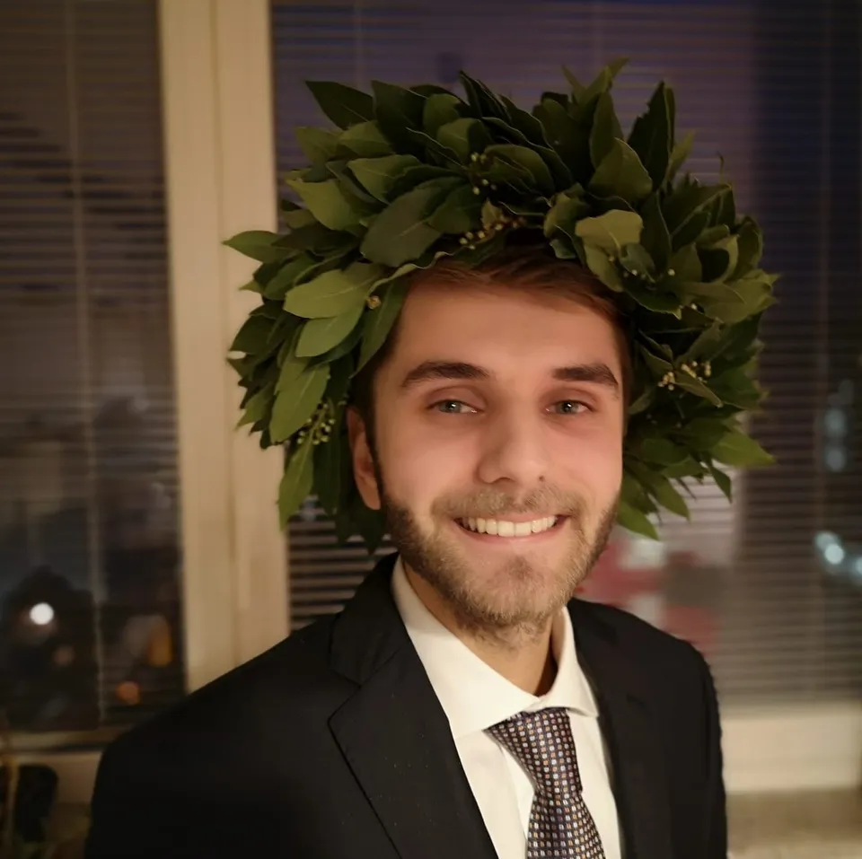 Gabriele with a laurel crown after his graduation from home during COVID social distancing.